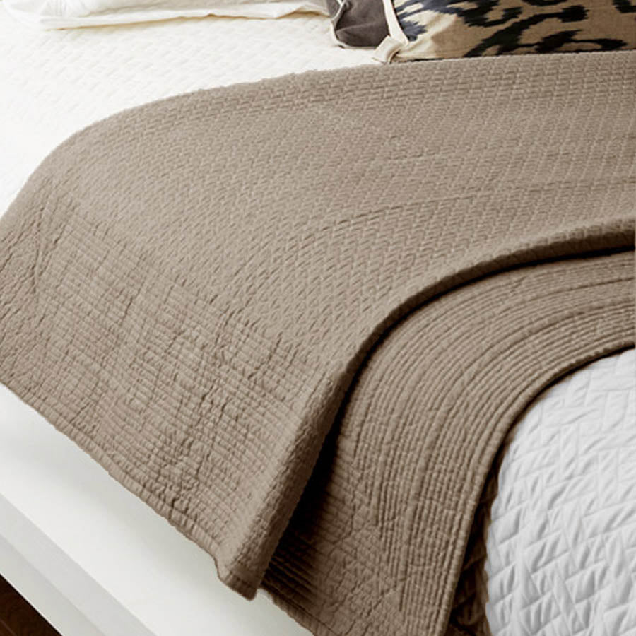 Close-up of the Flaxfield Linen Resort Quilted Bedspread in Mushroom, showing the geometric quilting and bound edge detail