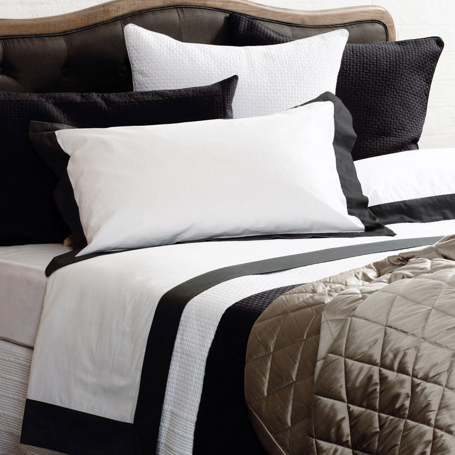 Black and white Resort sheet set showing black European-style border and matching pillowcases on a neatly styled bed.