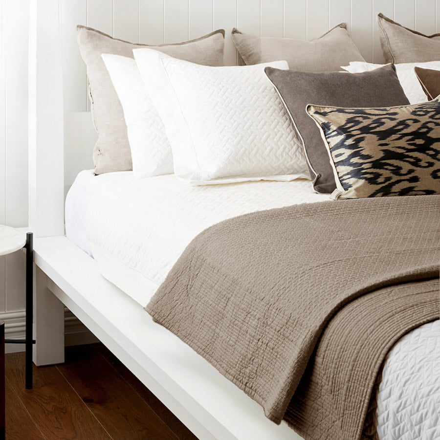 Mushroom resort quilted bedspread in 100% cotton percale, styled on a white bed – perfect all-season bedding