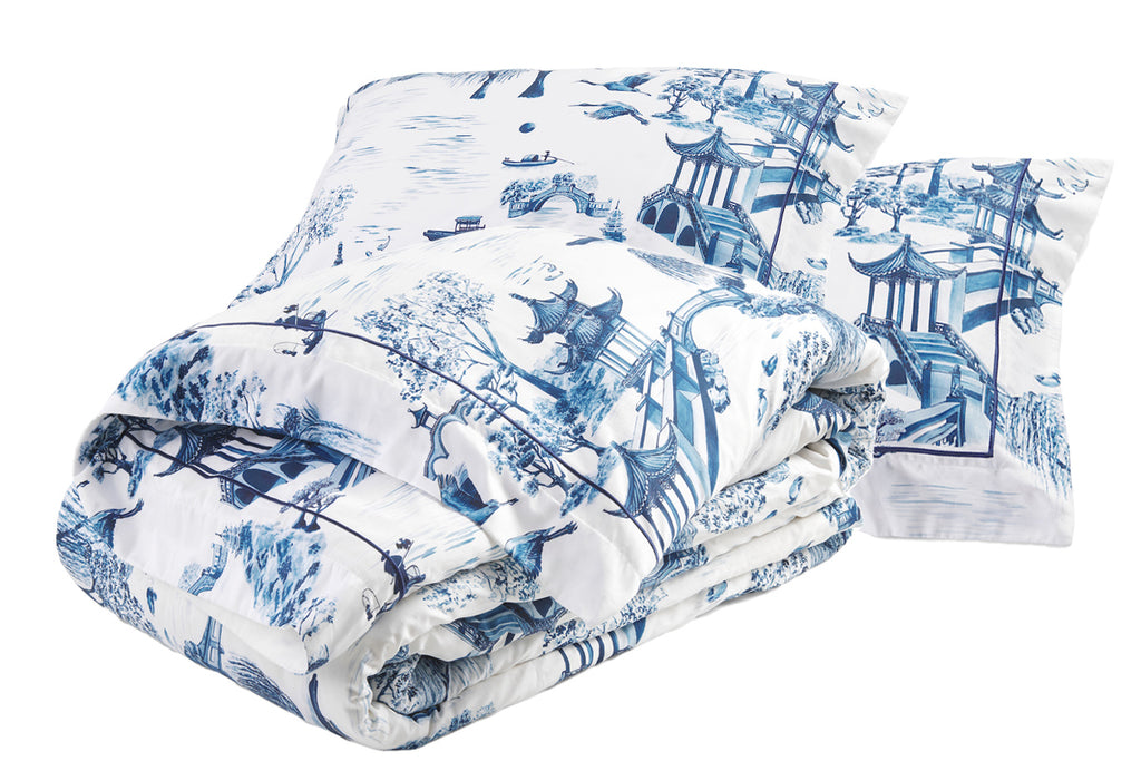 Willow Luxury Bedding Set consisting of a duvet cover and pair of pillowcases, printed with an intricate blue and white pattern reminiscent of 18th Century porcelain. The pillowcases are detailed with satin stitch embroidery around a 7cm flange. Each item is made from soft, durable, long-staple cotton sateen