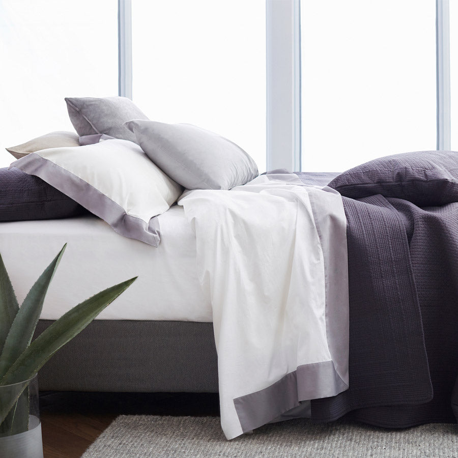 Deep sided white cotton fitted sheet styled on a deep mattress