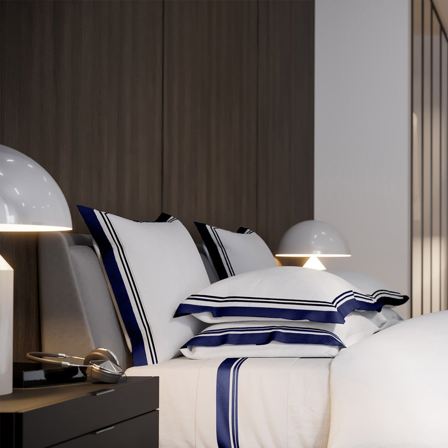 Flaxfield Linen Manhattan bedding set styled in a luxury suite, featuring the duvet cover and pillowcases in navy and white, enhancing the room's elegant decor.