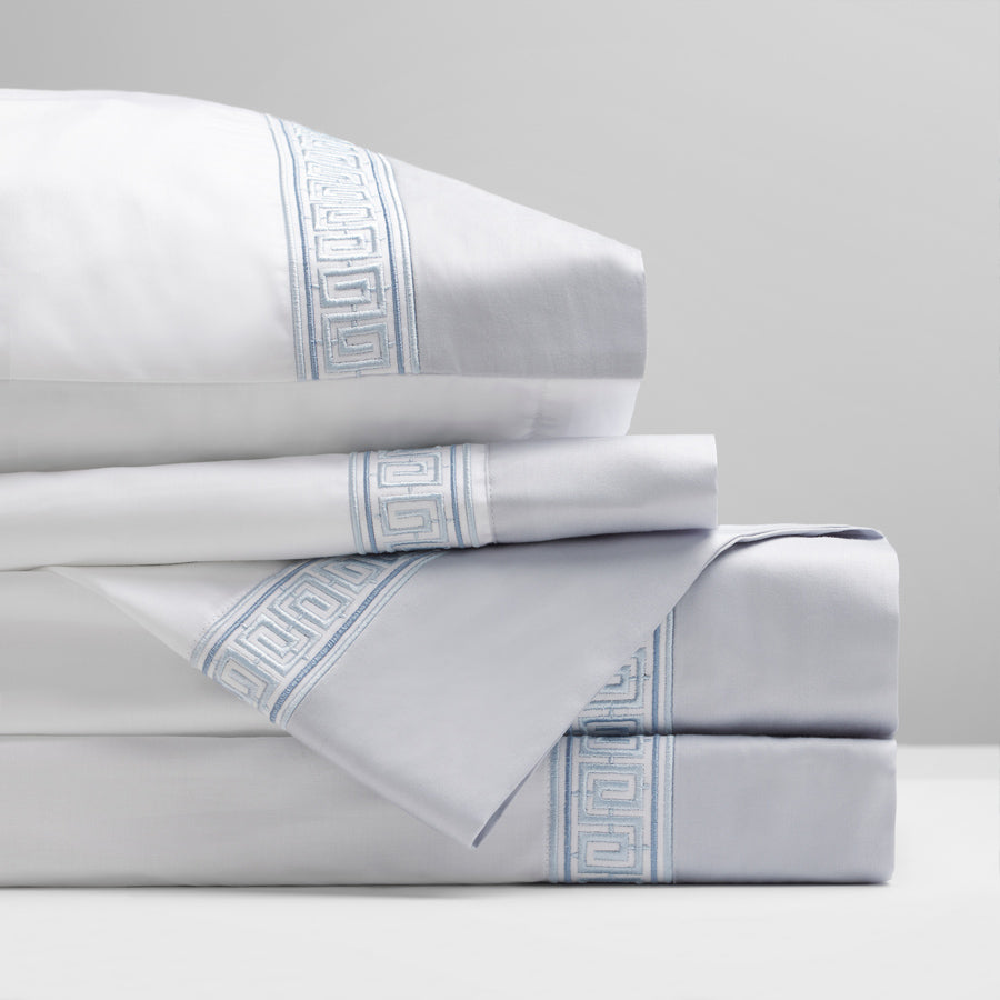 Rhodes Flat Sheet Set in serene blue, featuring 400 thread count long-staple cotton sateen, with elegant Grecian Meander motifs for a luxurious and refined bedroom decor.