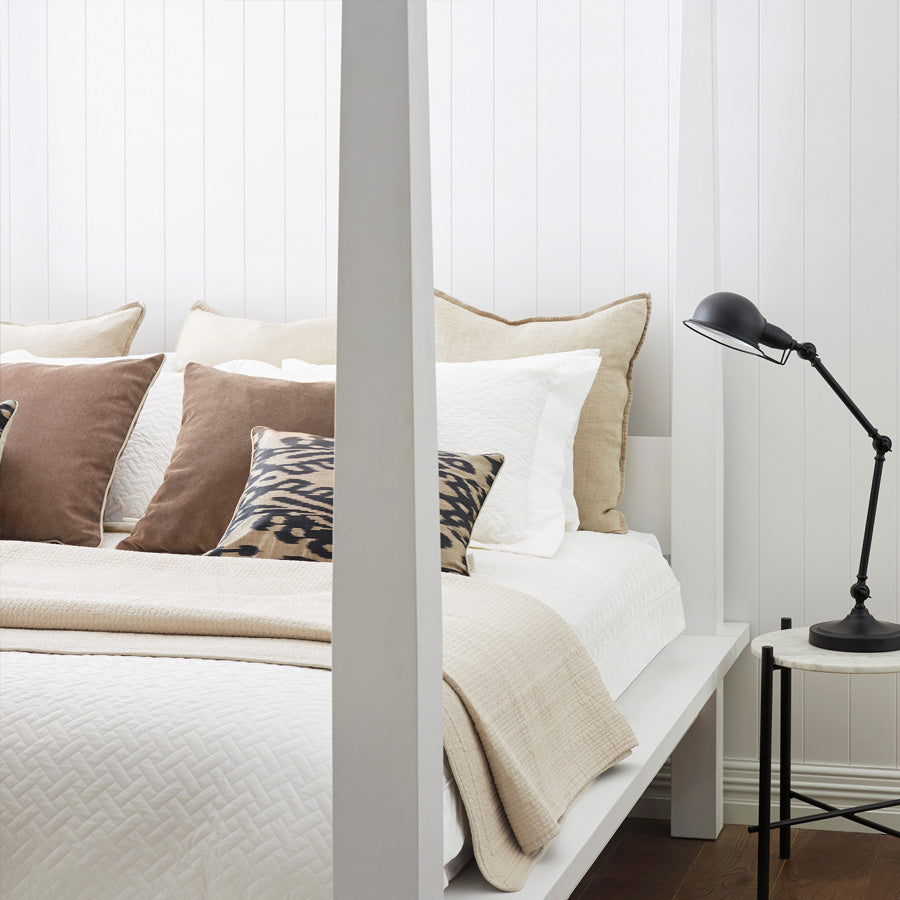 bed showcasing a quilted bedspread in linen