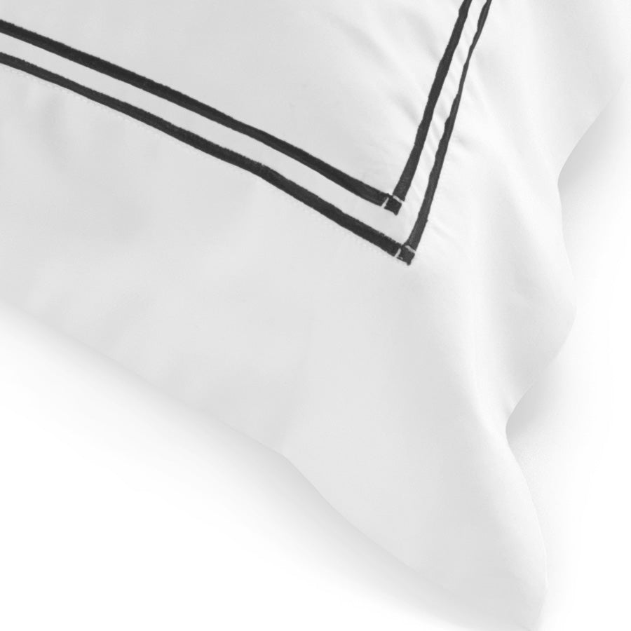 Close-up of the black dual satin-stitch embroidery on the Classique King Pillowcase