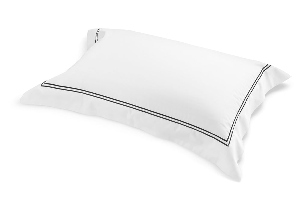 Single Classique King Pillowcase in white cotton sateen with black satin-stitch detail.