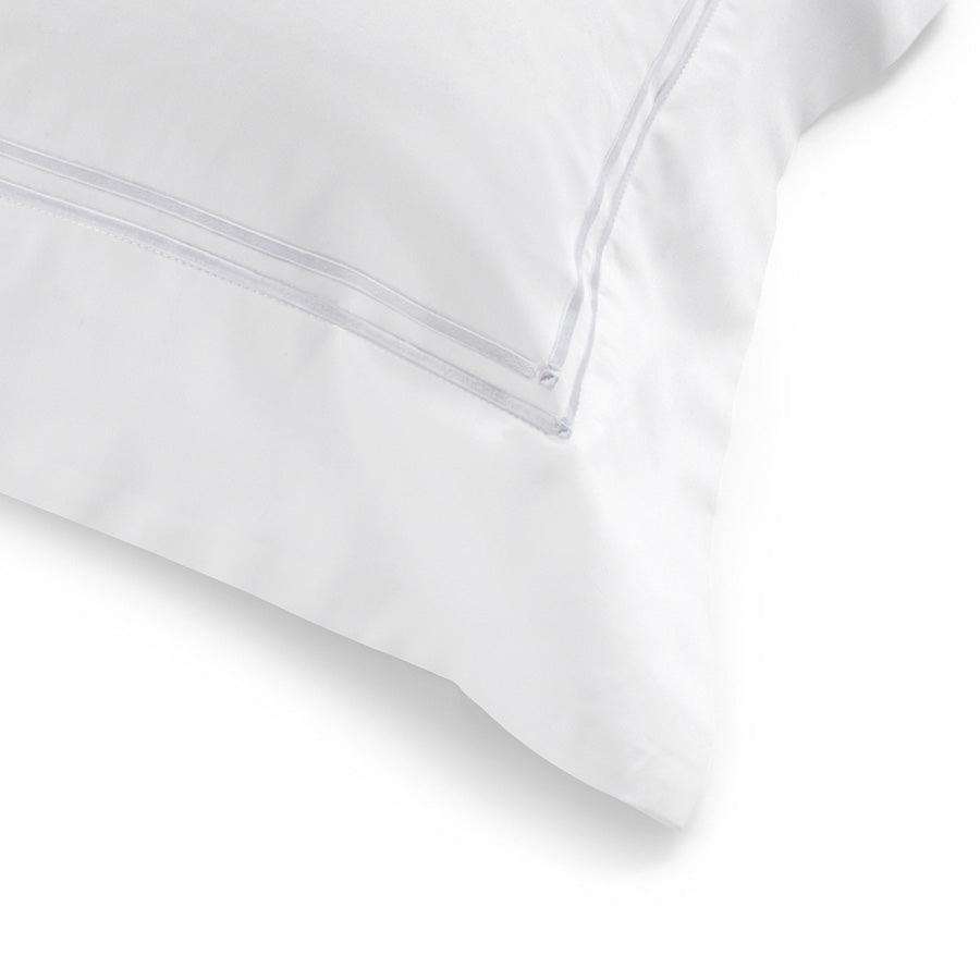 Close-up of the white dual satin-stitch embroidery and tailored 7.5cm flange on the Classique King Pillowcase.