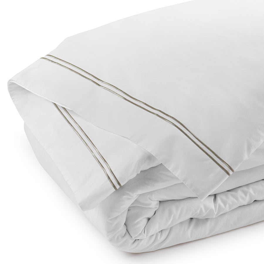 Folded white duvet cover featuring pewter double satin-stitch embroidery along the border