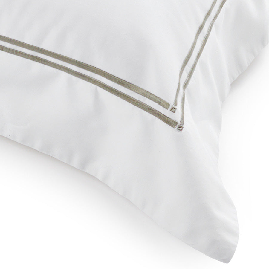 Pair of white cotton sateen pillowcases with pewter satin-stitch embroidered borders
