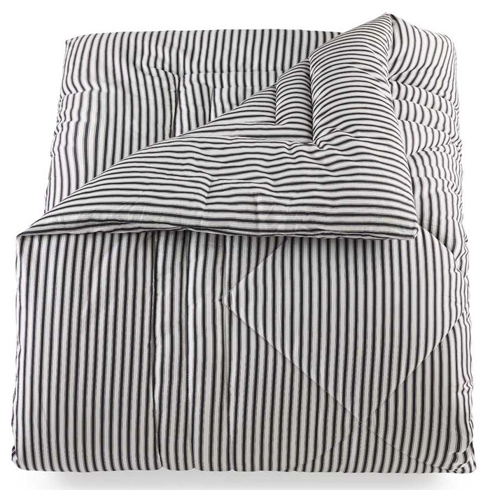 A folded Lyon comforter with a classic black and white ticking striped pattern on it, displayed on a white background.