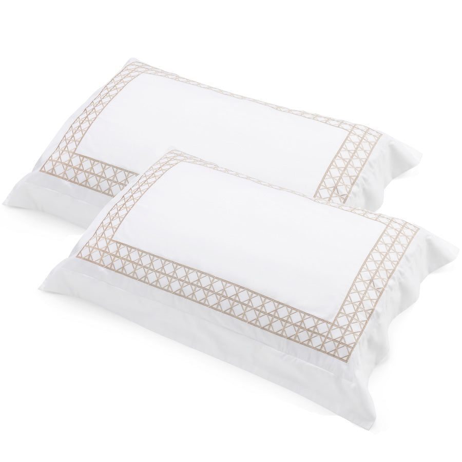 Pair of white cotton sateen tailored pillowcases with rattan-weave embroidered border by Flaxfield Linen.