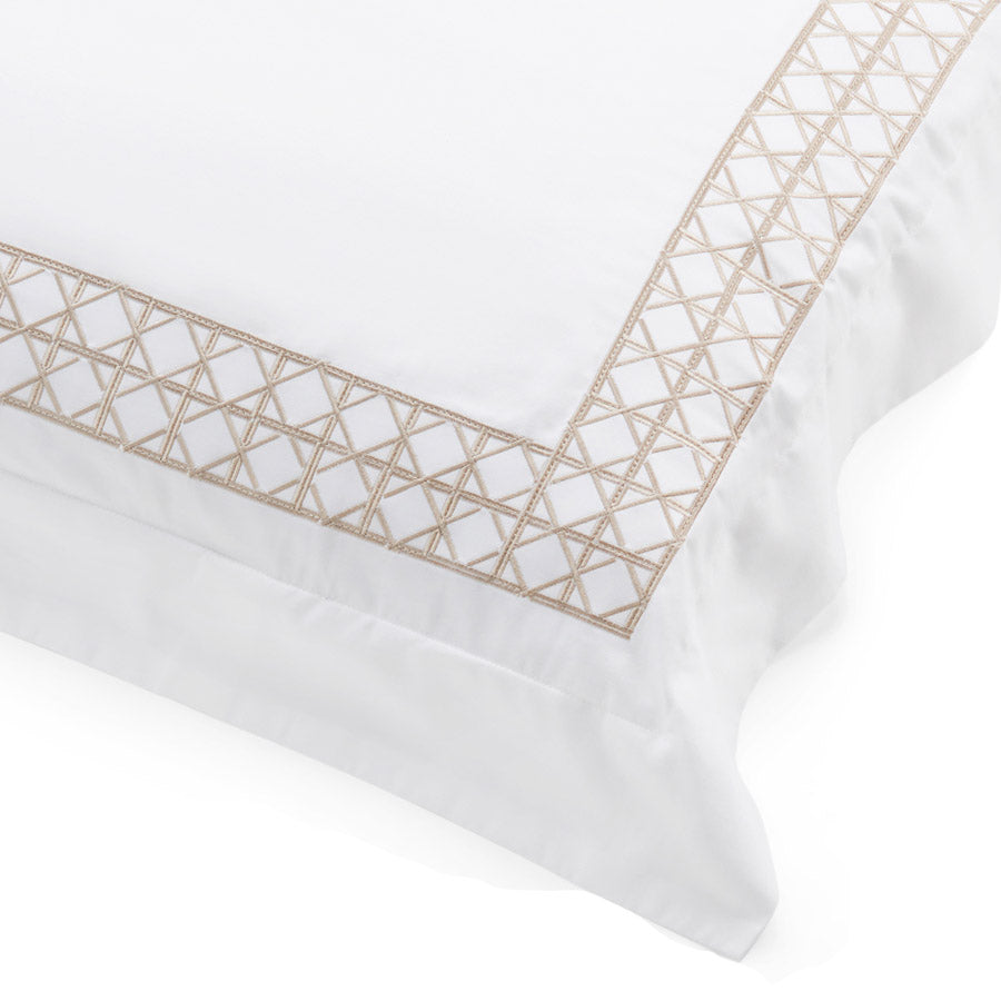 Close-up of rattan-weave embroidery on white cotton sateen pillowcase.