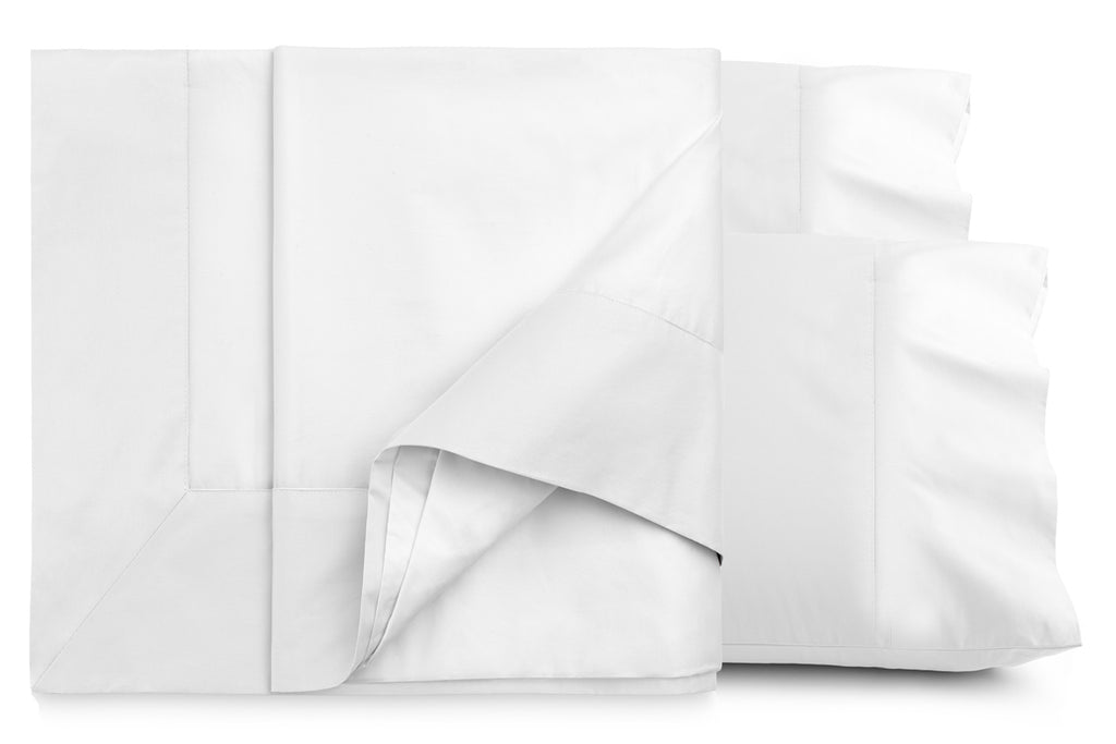 Folded white Resort sheet set showing flat sheet with turnback and matching cuffed pillowcases, cotton sateen fabric.